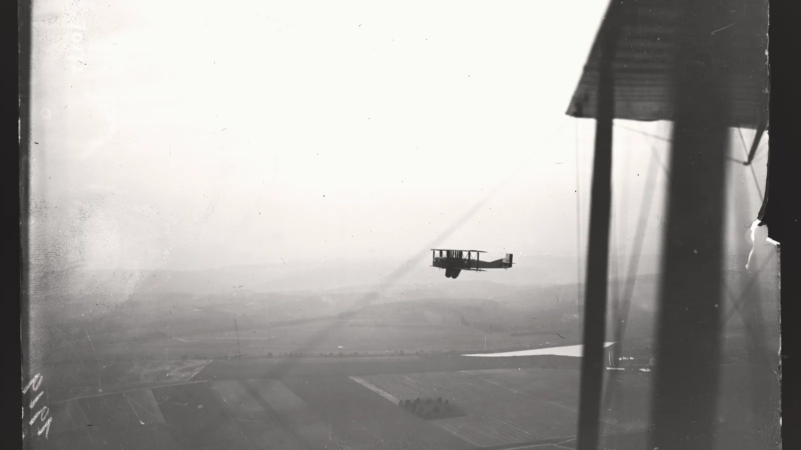 A 1919 Goliath airliner seen in flight from another aircraft, black and white photograph