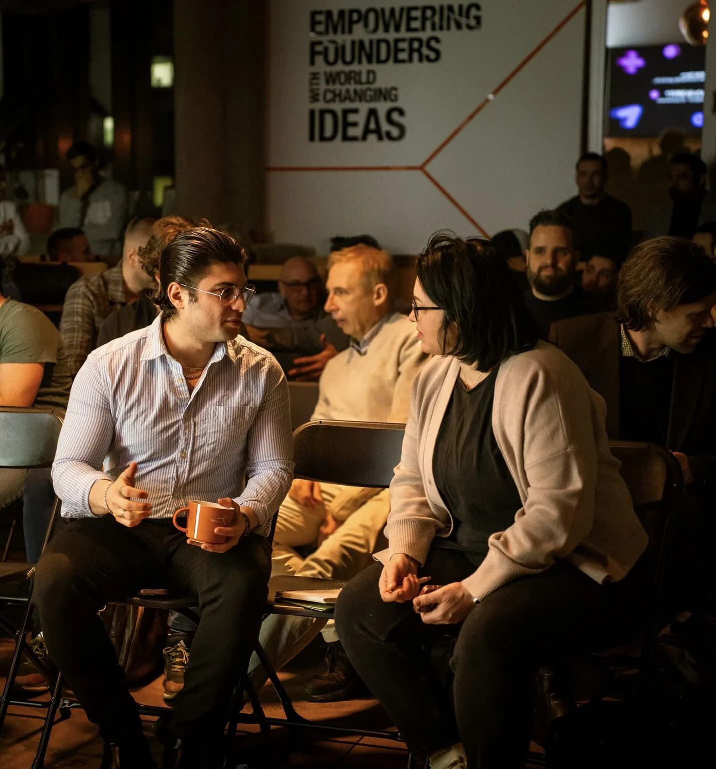 Fragnatique at a Tehnopol Startup Incubator evening, under the Empowering Founders wall in Tallinn