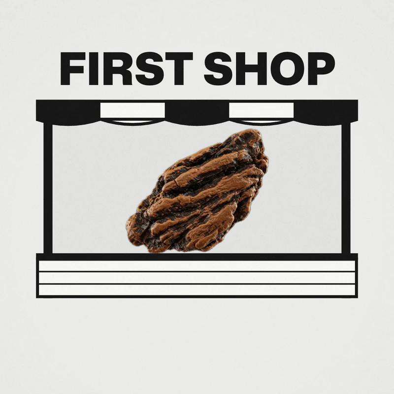A frame from our Eau Facts video: the words FIRST SHOP above a drawn market stall, with our photo of a dark oud chip on the counter